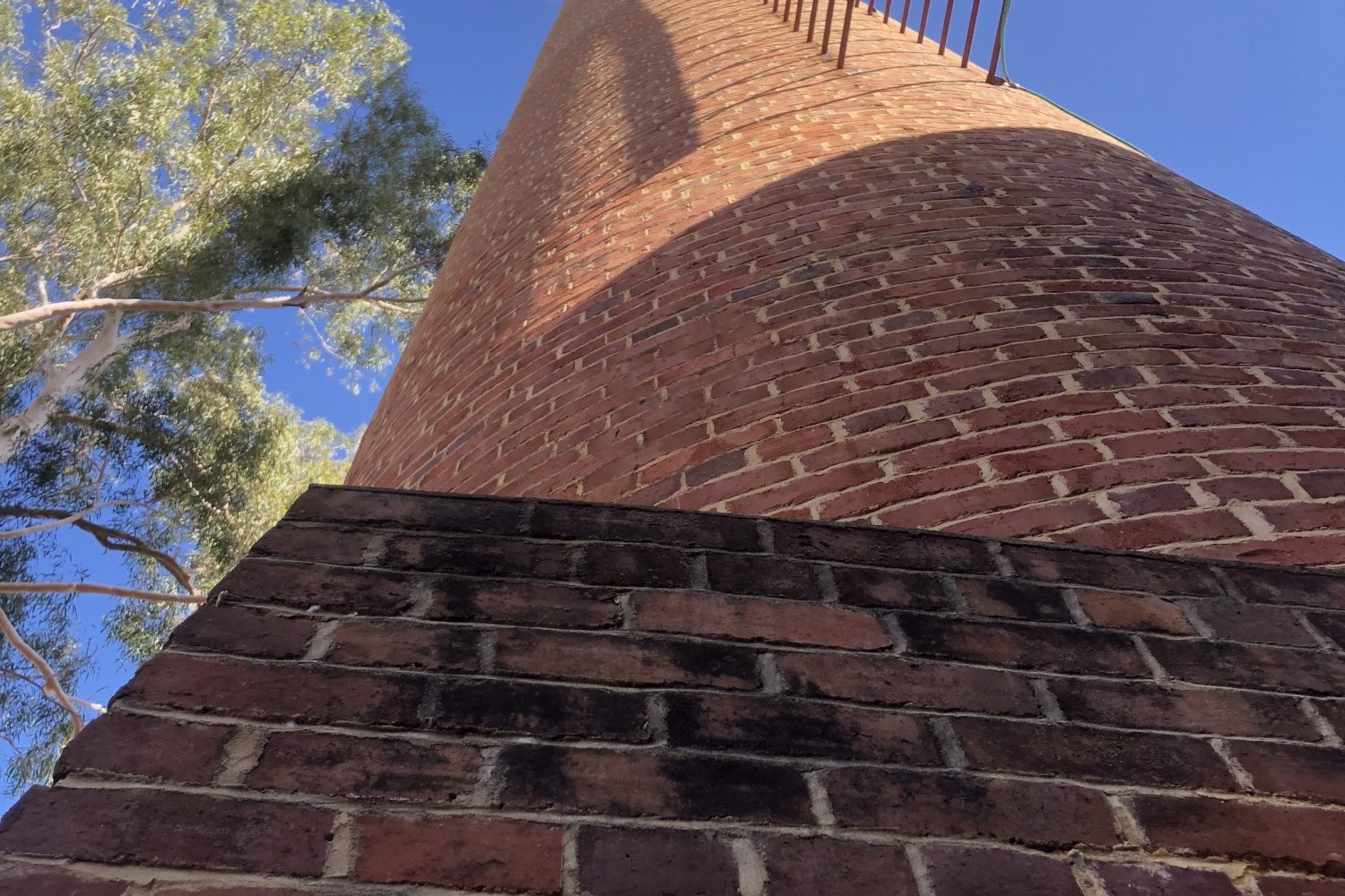 Looking up at the old brick chiminey at the original pump station 1 at the Mundaring Weir another stop on a Perth Hills Mountain Bike tour.