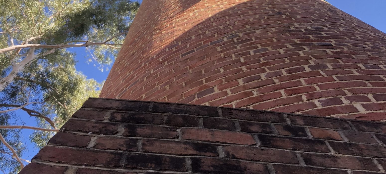 Looking up at the old brick chiminey at the original pump station 1 at the Mundaring Weir another stop on a Perth Hills Mountain Bike tour.